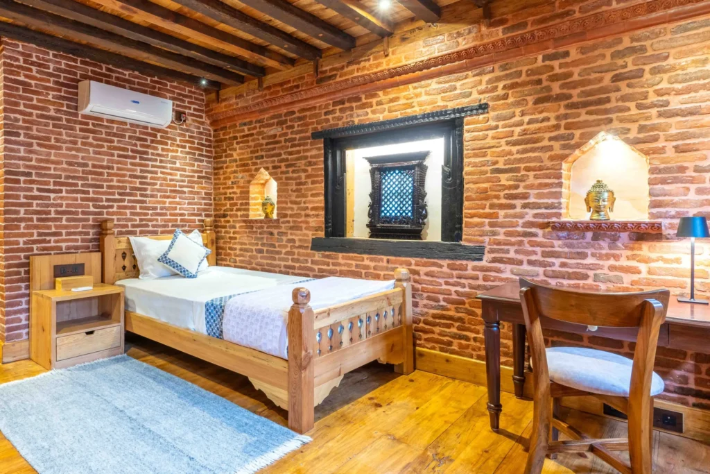 A hotel bed room at Patan designed traditionally along with other hotel amenities.